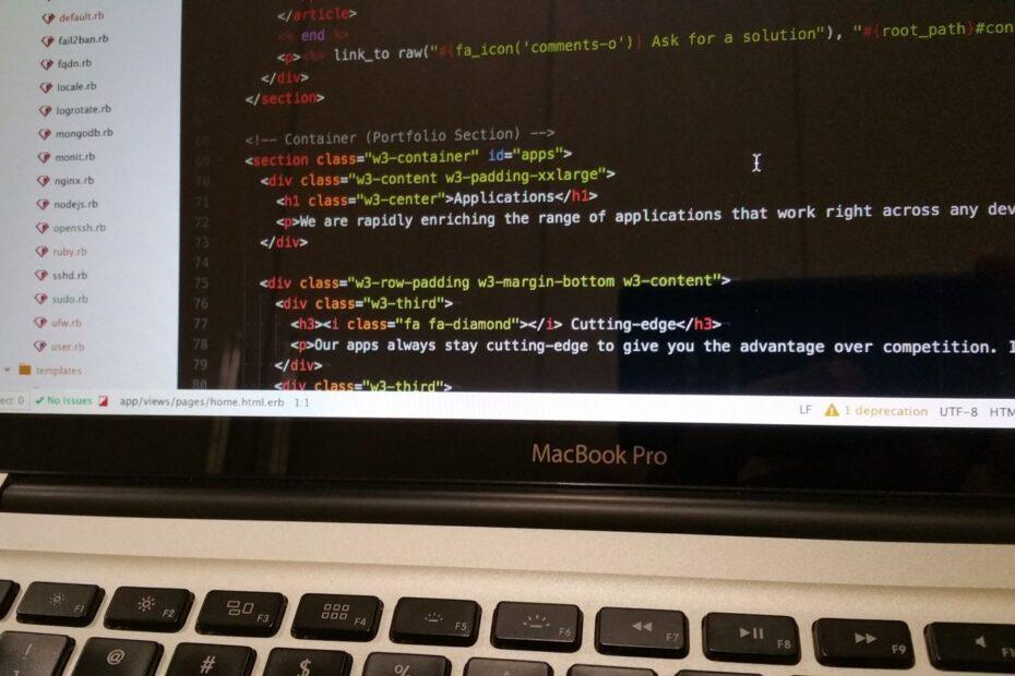 Close-up of HTML code displayed on a MacBook Pro screen, showcasing modern web development.